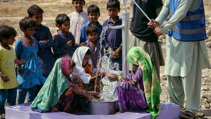 Children around water pump